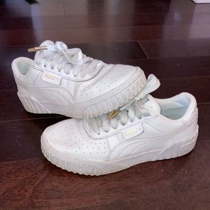 All white Puma Carina Leather Sneakers
